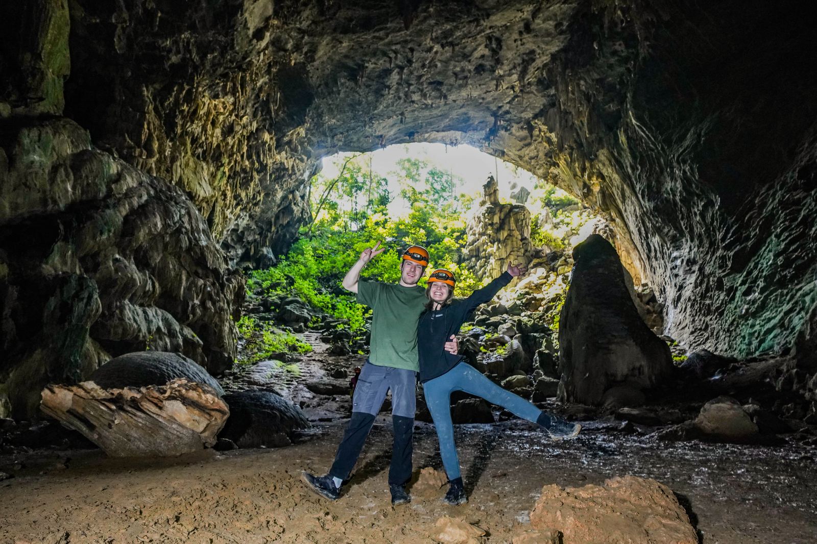 Traveler jumping for joy at the mouth of Elephant Cave